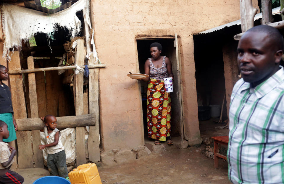 (C-R) Christine Manirafasha, 26, and her husband, Jean Claude Niyibizi, 30, who are the recipients of an Oxfam biogas digester, prepare to eat some eggs they've cooked with it on November 16, 2017 in their home in Gakenke, Rwanda. Manirafasha says it is easier and quicker to cook with biogas, and that smoke had become a problem while cooking with wood. Her only adjustment, she says, was to remember to turn the gauge to the off position. Having the digester has also allowed her to develop other activities, like a chicken farm and tailoring business. (Photograph by Yana Paskova)