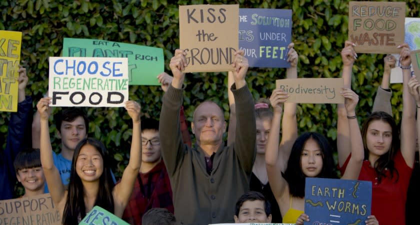 Wood Harrelson, center, is the narrator of the documentary "Kiss the Ground."