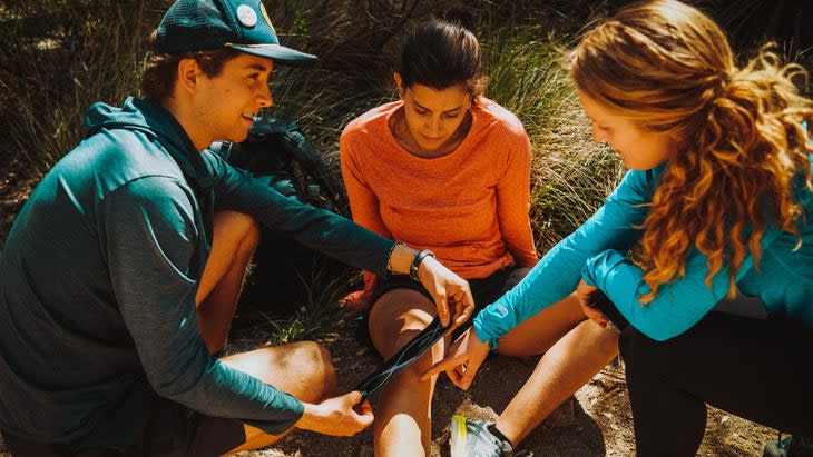 Morgan Brosnihan teaches hikers how to use athletic tape to prevent injuries