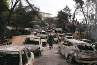 <p>A firefighter walks among burned cars, following a wildfire at the village of Mati, near Athens, Greece, July 24, 2018. (Photo: Costas Baltas/Reuters) </p>