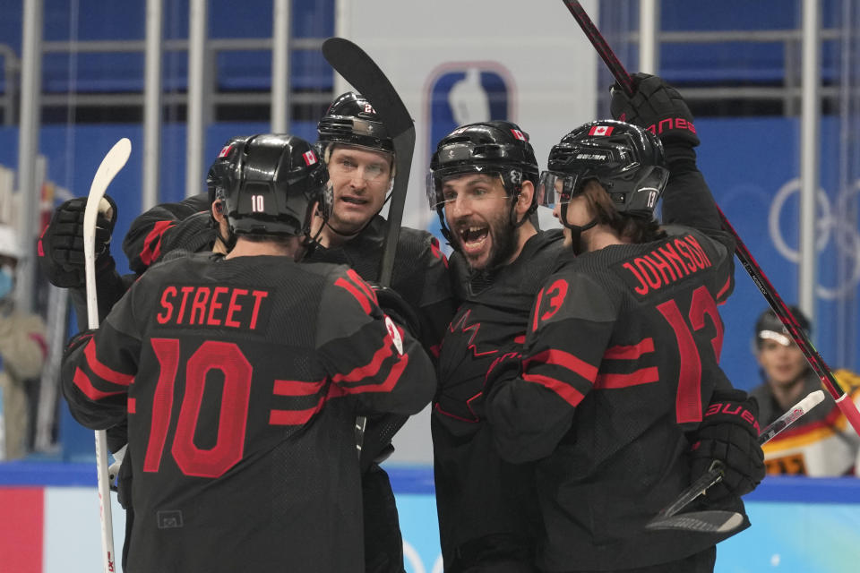 Canada's Ben Street (10) is congratulated after scoring a goal against Germany during a preliminary round men's hockey game at the 2022 Winter Olympics, Thursday, Feb. 10, 2022, in Beijing. (AP Photo/Petr David Josek)