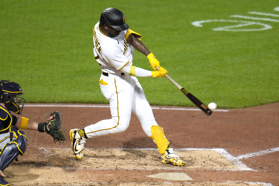 Pittsburgh Pirates' Andrew McCutchen, right, hits a double off Milwaukee Brewers starting pitcher Corbin Burnes, driving in a run, during the fifth inning of a baseball game in Pittsburgh, Monday, Sept. 4, 2023. (AP Photo/Gene J. Puskar)