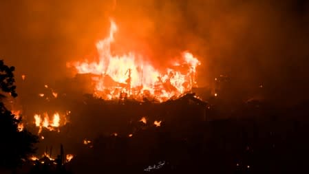 Flames engulf a slum after a fire broke out in Dhaka