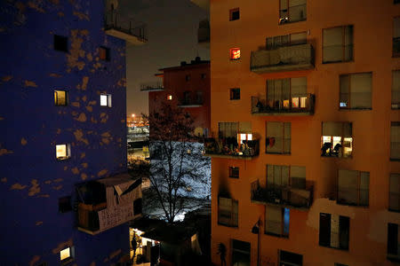 Light emanates from the windows of three of the four occupied buildings by migrants of the former Olympic village in Turin, Italy January 12, 2018. Picture taken January 12, 2018. REUTERS/Siegfried Modola