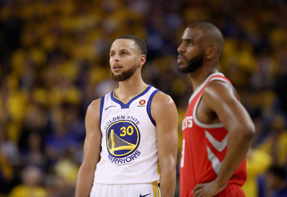 OAKLAND, CA - MAY 20:  Stephen Curry #30 of the Golden State Warriors stands next to Chris Paul #3 of the Houston Rockets during Game Three of the Western Conference Finals at ORACLE Arena on May 20, 2018 in Oakland, California. NOTE TO USER: User expressly acknowledges and agrees that, by downloading and or using this photograph, User is consenting to the terms and conditions of the Getty Images License Agreement.  (Photo by Ezra Shaw/Getty Images)