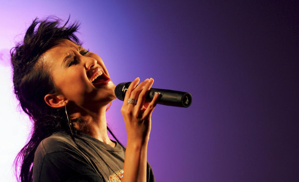 FILE - Hong Kong singer Coco Lee performs during a mini concert as celebrating an opening ceremony of a new hotel in Hong Kong, Friday, August 19, 2005. Coco Lee, a Hong Kong-born singer who had a highly successful career in Asia, died on Wednesday, July 5, 2023. She was 48. (AP/Kin Cheung, File)