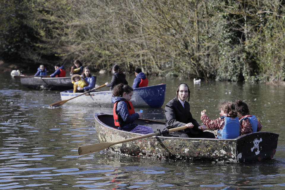 Families enjoy a boating lake in Finsbury Park as lockdown measures start to be relaxed in London, Friday, April 2, 2021. (AP Photo/Kirsty Wigglesworth)