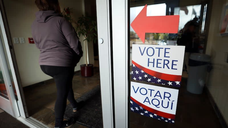 A woman walks past “Vote Here” signs at Taylorsville City Hall on Election Day in Taylorsville on Nov. 8, 2022. The House has passed a bill to end ranked choice voting in Utah elections.