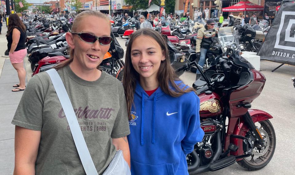 Crystal Hammer and her 19-year-old daughter Jayda Hammer of Aberdeen, S.D., shared a light moment while people watching on Main Street in Sturgis during the 2023 cycle rally.