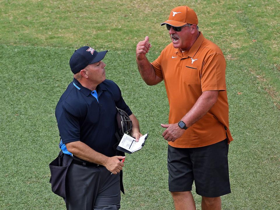 Texas coach Mike White argues with an umpire during a game against Oklahoma State on May 13, 2022.