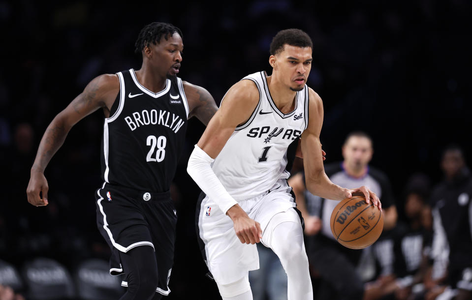 San Antonio Spurs center Victor Wembanyama (1) drives to the basket against Brooklyn Nets forward Dorian Finney-Smith (28) during the second half of an NBA basketball game, Saturday, Feb. 10, 2024, in New York. (AP Photo/Noah K. Murray)