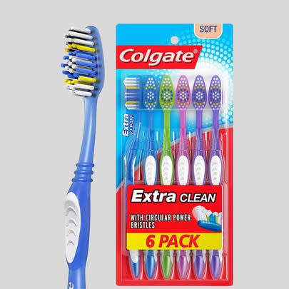 A pack of Colgate Extra Clean soft toothbrushes