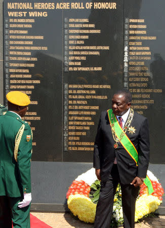 Zimbabwe's President Emmerson Mnangagwa looks on after lying wreathes during the national 38th Heroes Day Commemorations at the Heroes Acre in Harare, Zimbabwe, August 13, 2018.REUTERS/Philimon Bulawayo