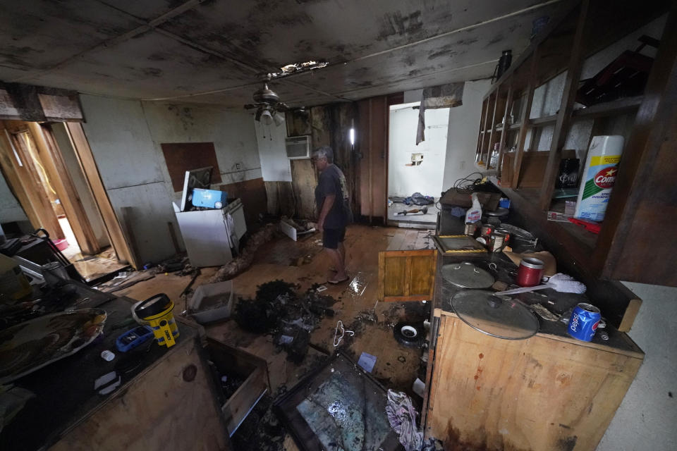Irene Verdin walks through her home that was heavily damaged by Hurricane Ida in August 2021, along Bayou Pointe-au-Chien, La., Tuesday, May 24, 2022. (AP Photo/Gerald Herbert)