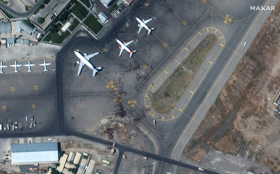 The chaotic scene underway at Kabul's Hamid Karzai International Airport in Afghanistan as thousands of people converged on the tarmac and airport runways as countries attempt to evacuate personnel from the city. (Satellite image 2021 Maxar Technologies)