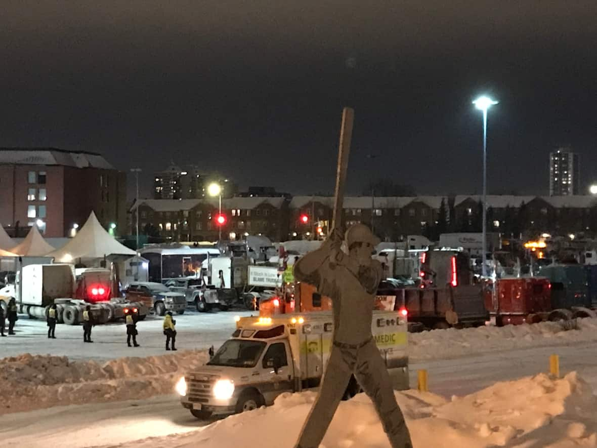 Police line up at the Coventry Road staging area in east Ottawa as they move in to confiscate fuel, vehicles and make arrests Sunday evening.  (CBC - image credit)