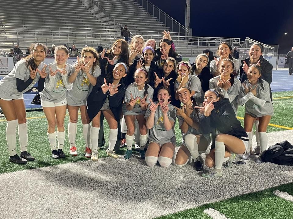 The Moorpark High girls soccer team celebrates after beating host Camarillo 2-1 in overtime on Wednesday night to capture the Coastal Canyon League championship.
