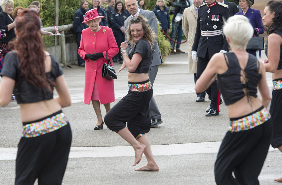 Queen Elizabeth II watches dancers perform as she visits Chester Zoo as part of her tour of the North West on May 17, 2012 in Chester, England