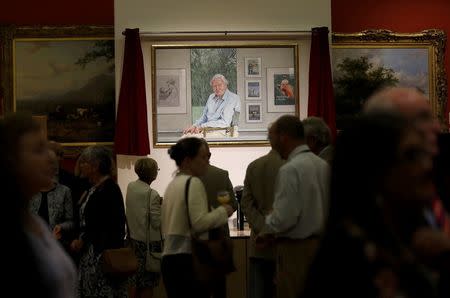 Visitors view a portrait of David Attenborough by Bryan Organ to mark his 90th birthday at New Walk Museum and Art Gallery in Leicester, Britain, September 22, 2016. REUTERS/Darren Staples