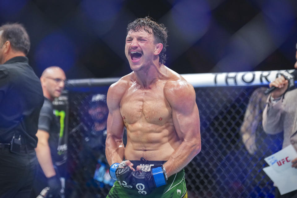 Jun 24, 2023; Jacksonville, Florida, USA; Jack Jenkins (blue gloves) celebrates after defeating Jamall Emmers (red gloves) in a featherweight bout during UFC Fight Night at VyStar Veterans Memorial Arena. Mandatory Credit: David Yeazell-USA TODAY Sports