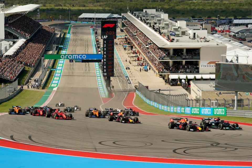 Mercedes driver Lewis Hamilton, of Britain, gets past Red Bull driver Max Verstappen, of the Netherlands in the first turn at the start of the Formula One U.S. Grand Prix auto race at the Circuit of the Americas