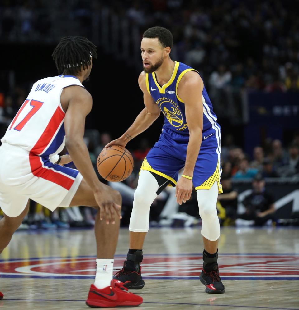 Detroit Pistons guard Stanley Umude (17) defends against Golden State Warriors guard Stephen Curry (30) during second-quarter action at Little Caesars Arena in Detroit on Monday, Nov. 6, 2023.