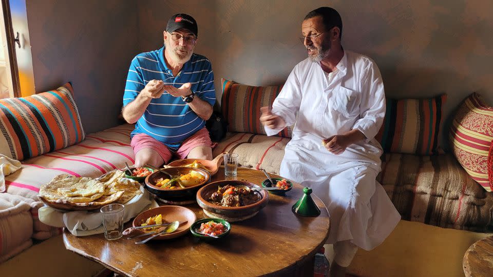 The author and his host sample the results of his Berber cooking lesson.  - Courtesy Tim Curran