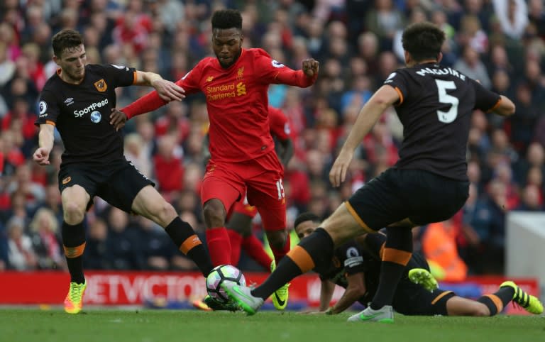 Liverpool's Daniel Sturridge under pressure form Hull City defenders Andrew Robertson (L) and Harry Maguire