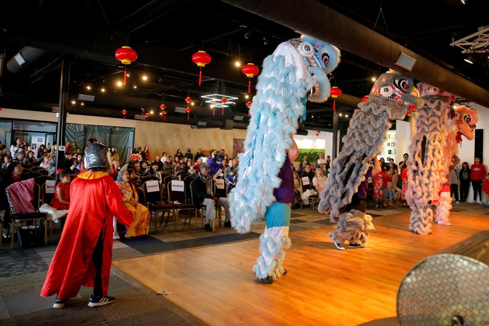 Members of GQ Lion Dance from the Giac Quang Temple performs a stunt on one another's shoulders during their performance at a Lunar New Year Celebration.