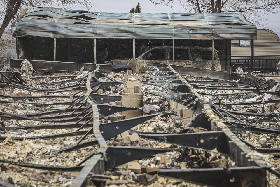 Clean up continues at a home destroyed by the Smokehouse Creek fire, Thursday, Feb. 29, 2024 in Canadian, Texas. A wildfire spreading across the Texas Panhandle has become the largest in state history. (AP Photo/David Erickson)