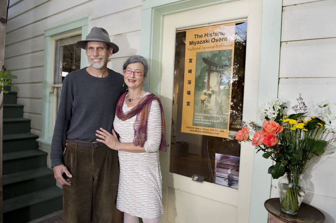 Longtime partners Eugene Phillips, left, and Montserrat Wassam, co-owners of the Miyazaki Bath House, stand outside the historic business in the Delta town of Walnut Grove in 2014.