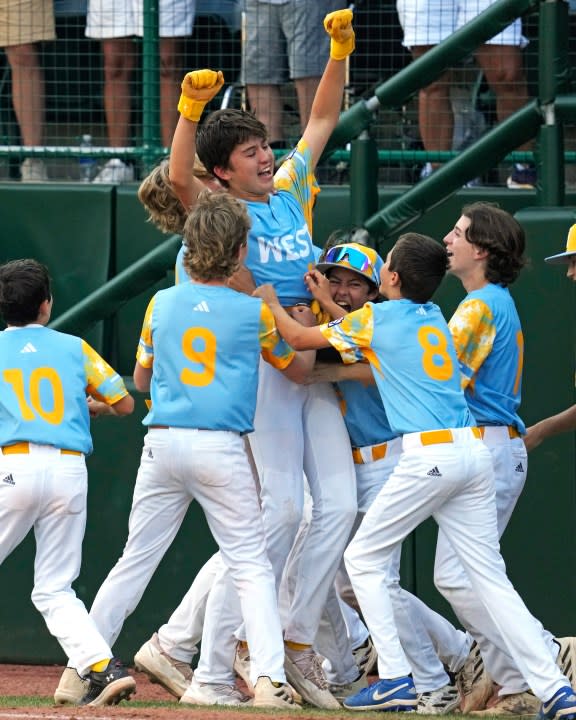 El Segundo, Calif.’s Louis Lappe, center, celebrates with teammates after hitting a solo walk-off home run off Curacao’s Jay-Dlynn Wiel during the sixth inning of the Little League World Series Championship game in South Williamsport, Pa., Sunday, Aug. 27, 2023. California won 6-5. (AP Photo/Gene J. Puskar)