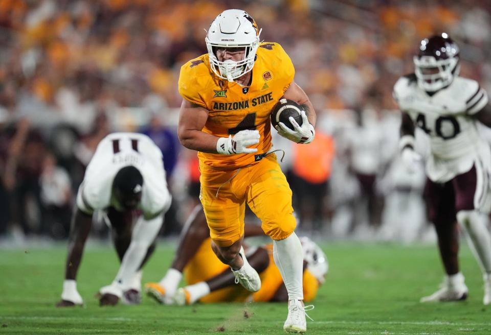 Arizona State running back Cam Skattebo (4) runs with the ball against the Mississippi State Bulldogs at Mountain America Stadium in Tempe on Sept. 7, 2024.