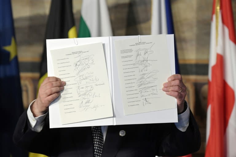 EU Parliament president Antonio Tajani holds up the new Rome declaration signed by leaders of 27 European Union countries during a summit of EU leaders to mark the 60th anniversary of the bloc's founding Treaty of Rome, in Rome on March 25, 2017