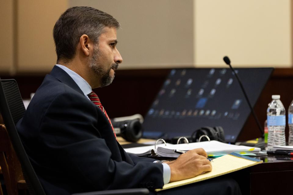 Defense attorney Daniel Rashbaum takes notes as his client, Charlie Adelson is cross examined by the prosecution team Friday, Nov. 3, 2023.