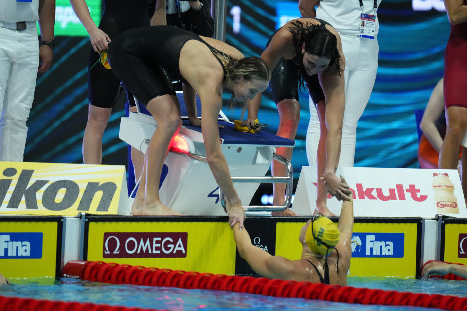 Members of team Australia celebrate after winning the women's 4x100m freestyle relay final at the 19th FINA World Championships in Budapest, Hungary, Saturday, June 18, 2022. (AP Photo/Petr David Josek)