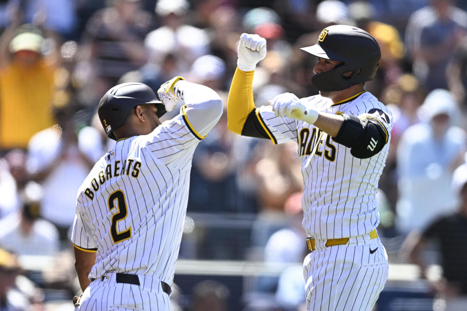 San Diego Padres' Kyle Higashioka, right, is congratulated by Xander Bogaerts after hitting a solo home run against the St. Louis Cardinals during the fourth inning of a baseball game Wednesday, April 3, 2024, in San Diego. (AP Photo/Denis Poroy)