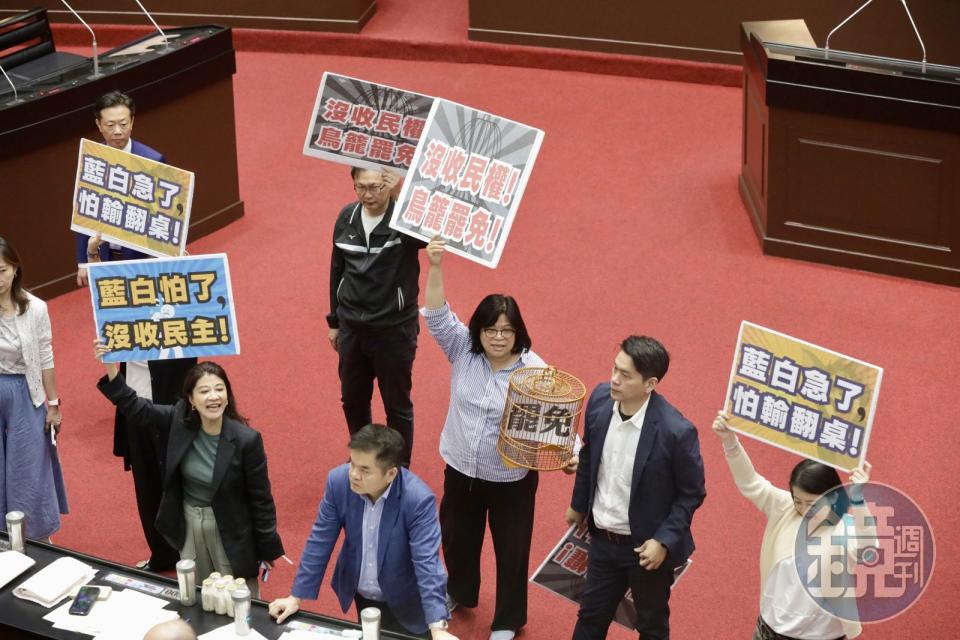 藍白因人數優勢，讓選罷法修法草案逕付二讀，引發民進黨立委舉牌抗議。