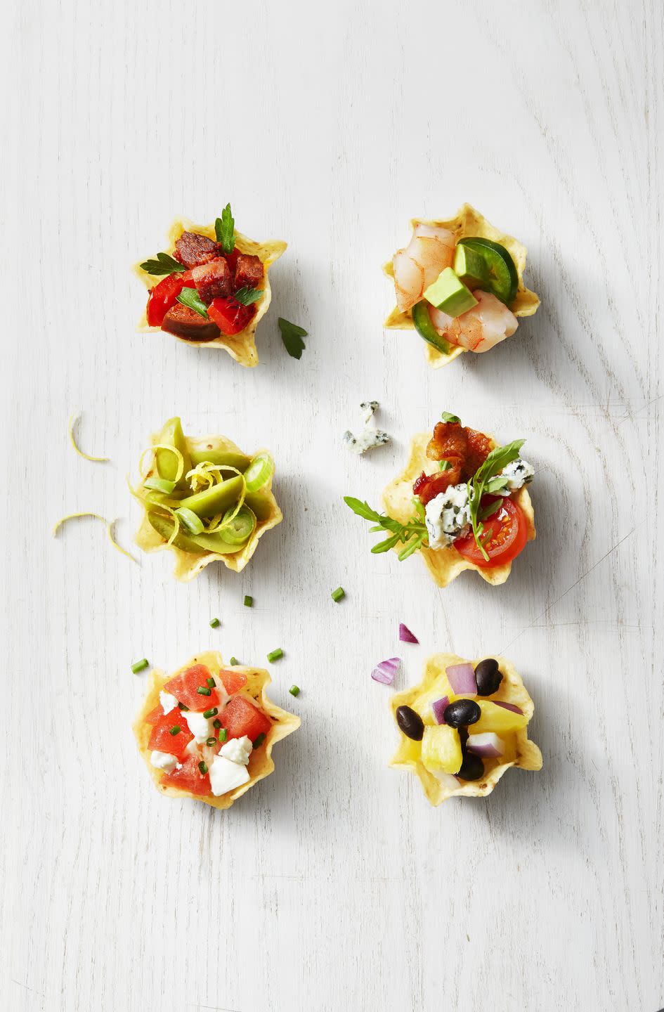 <p>If you're in need of a last-minute appetizer, these bites come together in minutes. Try our combos or get creative with anything you already have in the fridge and pantry.</p><p>Get the <strong><a href="https://www.goodhousekeeping.com/food-recipes/a35191279/stuffed-tortilla-cups-recipe/" rel="nofollow noopener" target="_blank" data-ylk="slk:Stuffed Tortilla Cups recipe;elm:context_link;itc:0;sec:content-canvas" class="link ">Stuffed Tortilla Cups recipe</a></strong>.</p>