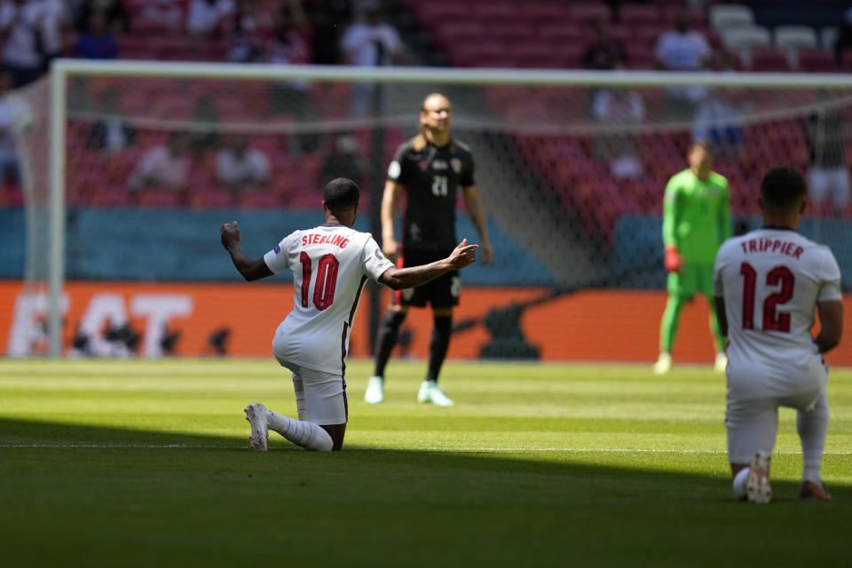 England's Raheem Sterling, left, takes the knee before the start of the Euro 2020 soccer championship group D match between England and Croatia at Wembley stadium in London, Sunday, June 13, 2021. (AP Photo/Frank Augstein, Pool)