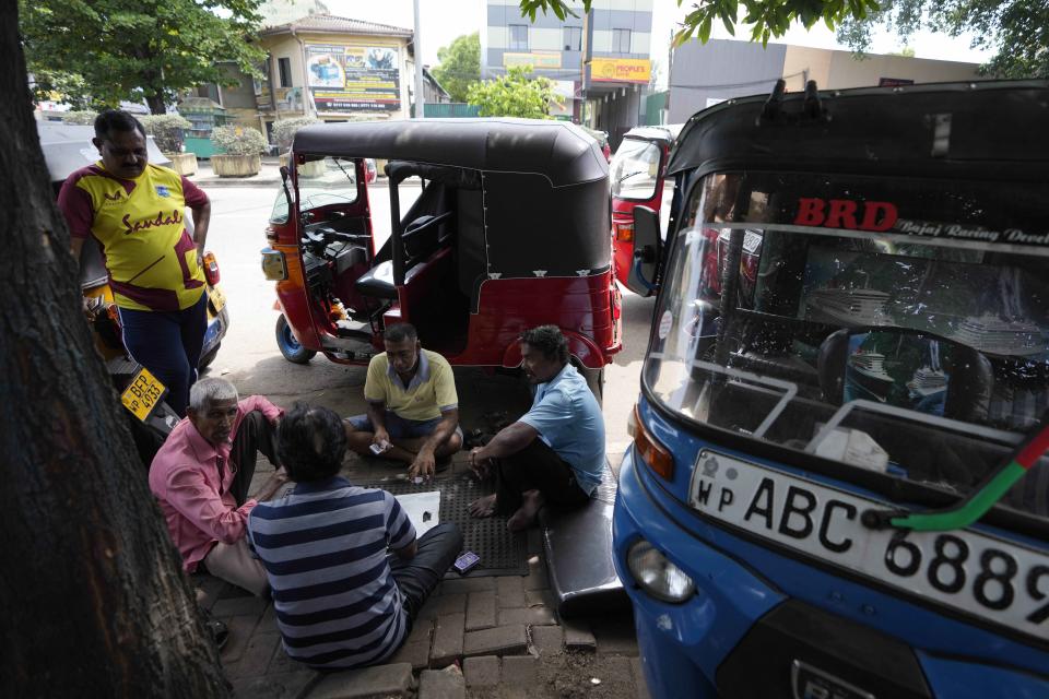 Auto rickshaw drivers wait to buy fuel in Colombo, Sri Lanka, Tuesday, July 5, 2022. Sri Lanka's ongoing negotiations with the International Monetary Fund have been complex and difficult than the instances before because it has entered talks as a bankrupt nation, the country's prime minister said Tuesday. (AP Photo/Eranga Jayawardena)