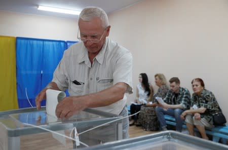 A voter casts his ballot at a polling station during Ukraine's parliamentary election in Kiev