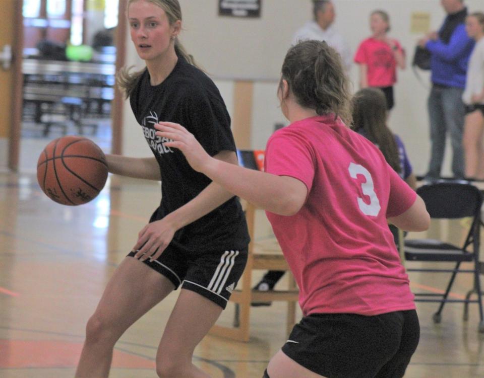 Bella Ecker (left) looks to get past Jersey Beauchamp during a Triple Threat 3-on-3 basketball tournament game at Cheboygan Middle School on Sunday, May 5. Ecker and Beauchamp both competed in the girls 17-18 division.