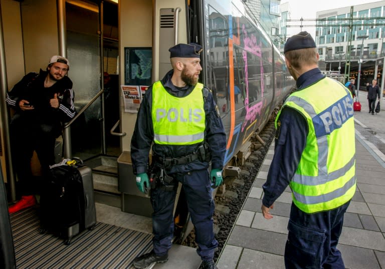 Swedish police prepare to check an incoming train at the Swedish end of the bridge between Sweden and Denmark in Malmo on November 12, 2015