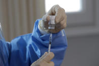 A nurse prepares for the first dose of the AstraZeneca COVID-19 vaccine at nursing home in Goyang, South Korea, Friday, Feb. 26, 2021. South Korea on Friday administered its first available shots of coronavirus vaccines to people at long-term care facilities, launching a mass immunization campaign that health authorities hope will restore some level of normalcy by the end of the year.(AP Photo/Lee Jin-man)