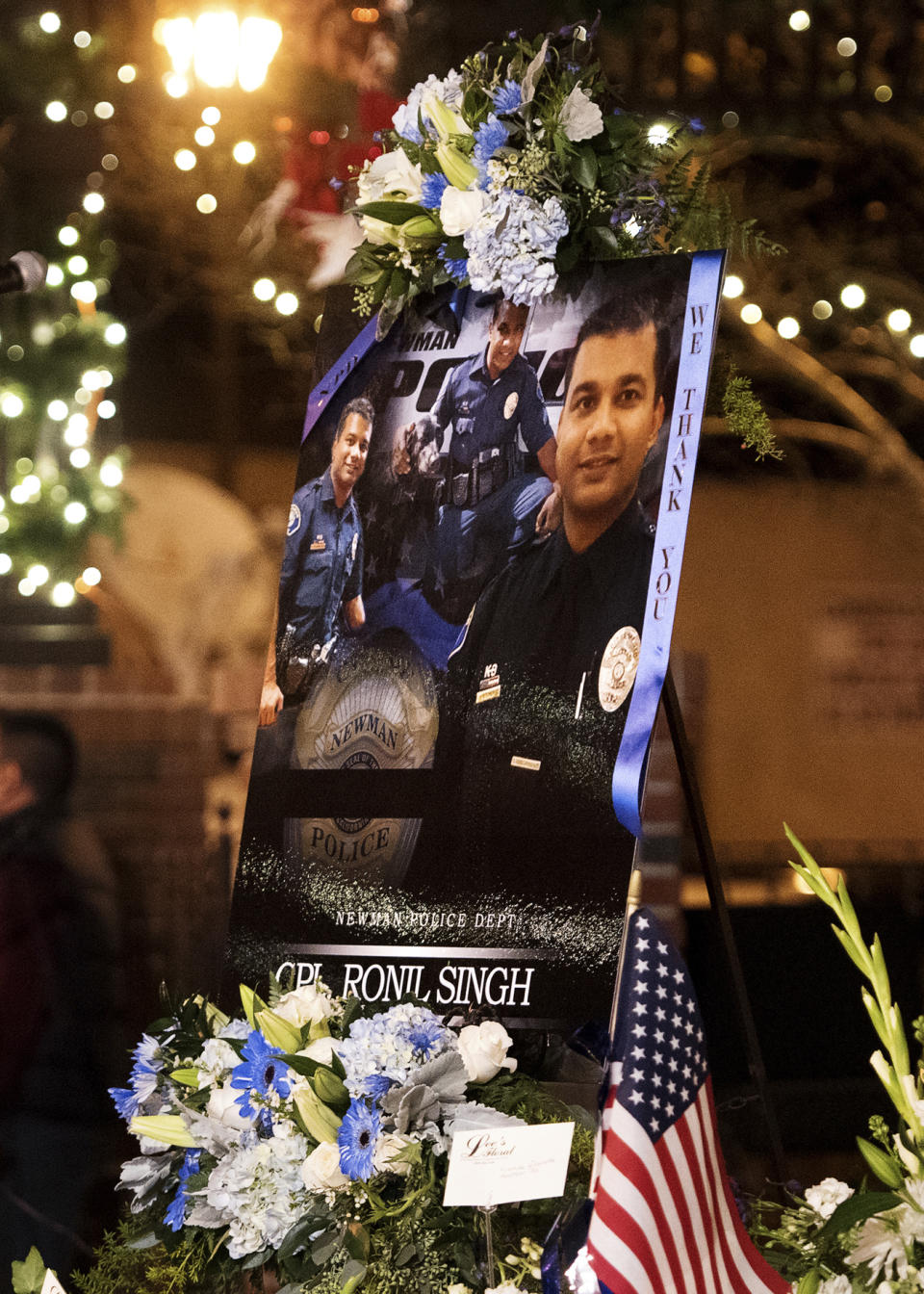 FILE - This Friday, Dec. 28, 2018 file photo shows a collection of pictures of police Cpl. Ronil Singh during a candlelight vigil in Newman, Calif. The Northern California police officer was gunned down during a traffic stop the day after Christmas 2018. (Andy Alfaro/The Modesto Bee via AP, File)