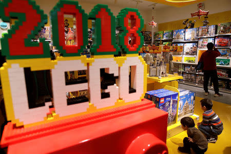 FILE PHOTO: Children look at Lego boxes at a Lego store in Beijing, China January 13, 2018. REUTERS/Jason Lee/File Photo