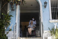 Zelia de Carvalho Morley, 106, is wheeled outdoors before receiving a shot of China's Sinovac CoronaVac vaccine for the new coronavirus at the retirement home where she lives in Rio de Janeiro, Brazil, Wednesday, Jan. 20, 2021. De Carvalho Morley lived through the 1918 flu pandemic. (AP Photo/Bruna Prado)