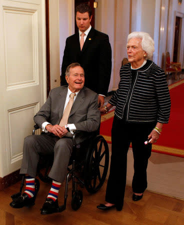 FILE PHOTO - Former U.S. President George H. W. Bush (L) and former first lady Barbara Bush enter the East Room of the White House before the ceremony unveiling the official White House portraits of former President George W. Bush and former first lady Laura Bush in the East Room of the White House in Washington in this file image from May 31, 2012. REUTERS/Larry Downing/File Photo