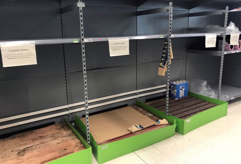 Empty shelves are seen on the toilet roll aisle inside an Asda supermarket in Milton Keynes